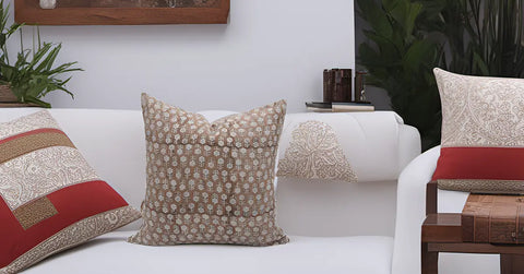 White sofa adorned with handmade pillow covers enhancing home decor.